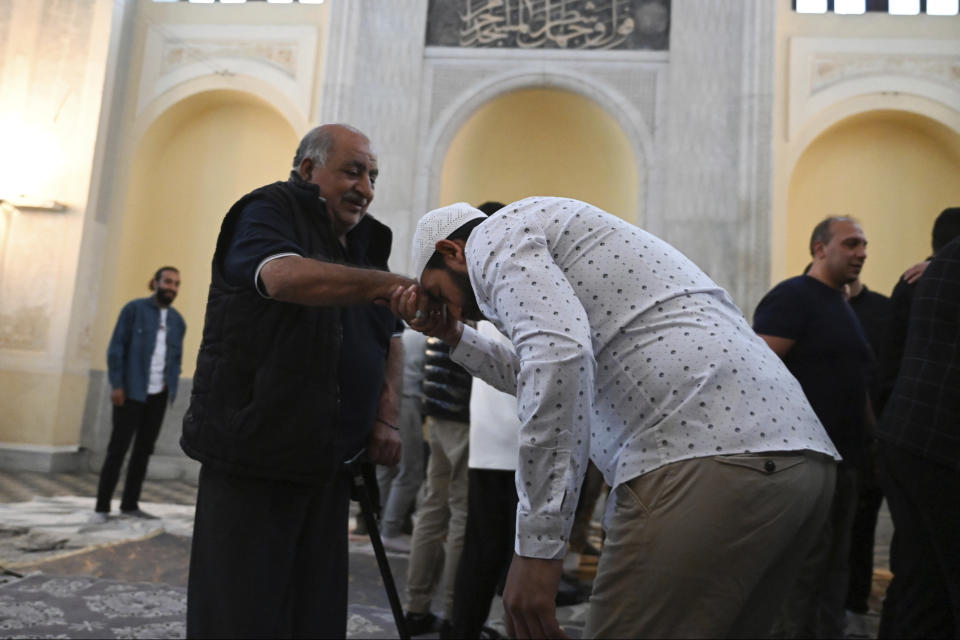 People attend the morning prayers at the historic Yeni Cami, or New Mosque, in the port city of Thessaloniki, northern Greece, Wednesday, April 10, 2024. Eid prayers were held in the historic former mosque in northern Greece for the first time in 100 years. (AP Photo/Giannis Papanikos)