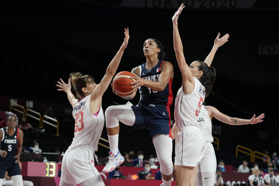 France's Gabrielle Williams (15) drives to the basket between Serbia's Tina Krajisnik (33) and Sonja Vasic (5) during a women's basketball bronze medal game at the 2020 Summer Olympics, Saturday, Aug. 7, 2021, in Saitama, Japan. (AP Photo/Eric Gay)