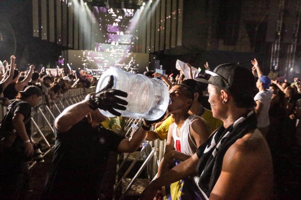 Security guards keeping festivalgoers hydrated at Ultra Singapore. (Photo: Yahoo Singapore)