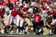 Wisconsin cornerback Lee Hutton (38) and safety Titus Toler (41) tackle Purdue running back Devin Mockobee (45) during the first half of an NCAA college football game Saturday, Oct. 22, 2022, in Madison, Wis. (AP Photo/Andy Manis)