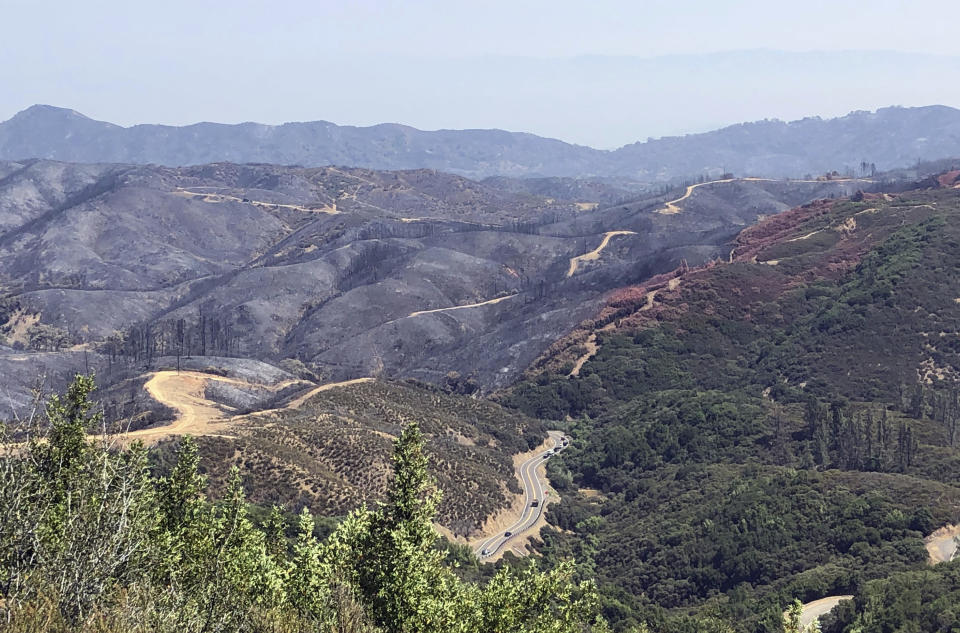 This photo taken Friday, Aug. 10, 2018 near Lakeport, Calif. shows dirt paths created by bulldozers in an effort to contain part of the largest wildfire on record in California. Firefighters are battling the largest wildfire on record in California, while foresters and other experts are working to repair the damage. Crews are smoothing out dirt roads and replacing fences to mitigate the damage caused not by flames but by the firefighters racing to extinguish them. They seek to restore private lands, protect the environment and water supply, and prevent erosion.(AP Photo/Jonathan J. Cooper)