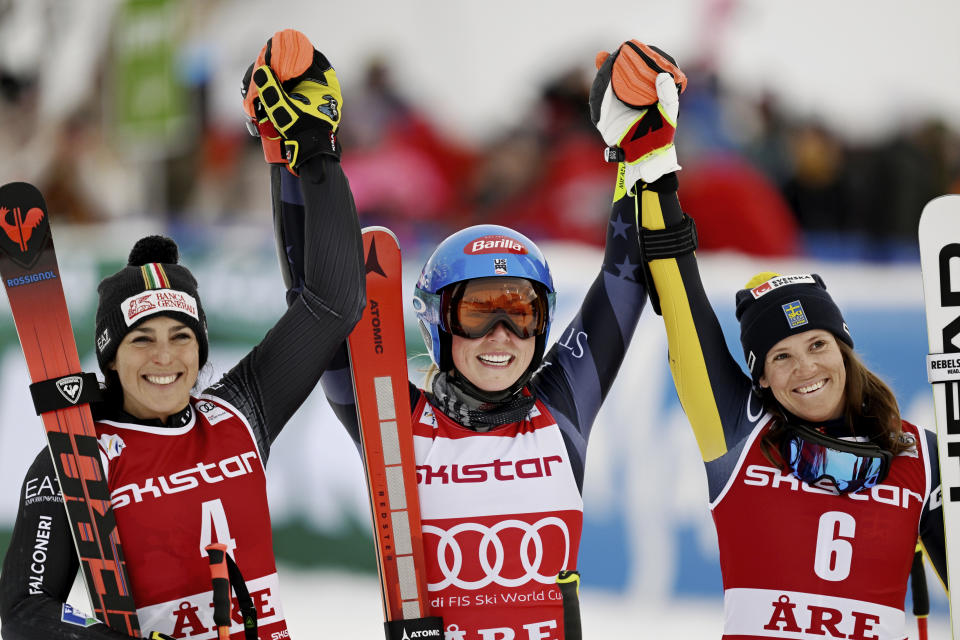 United States' Mikaela Shiffrin, center, winner of an alpine ski, women's World Cup giant slalom race, celebrates with second-placed Italy's Federica Brignone, left, and third-placed Sweden's Sara Hector, in Are, Sweden, Friday, March 10, 2023. Shiffrin has won her record-tying 86th World Cup race with victory in a giant slalom, matched the overall record set by Swedish great Ingemar Stenmark 34 years ago. (Pontus Lundahl/TT News Agency via AP)