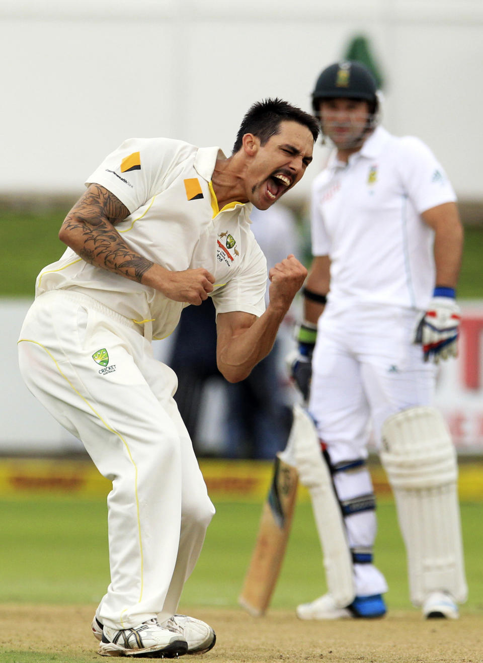 Australia's bowler Mitchell Johnson, left, reacts as South Africa's batsman Dean Elgar, right, watches after dismissing his teammate Hashim Amla, for a duck on the first day of their 2nd cricket test match at St George's Park in Port Elizabeth, South Africa, Thursday, Feb. 20, 2014. (AP Photo/ Themba Hadebe)