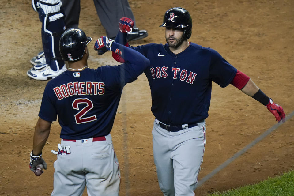 Boston Red Sox's J.D. Martinez, right, celebrates with teammate Xander Bogaerts after hitting a home run during the eighth inning of a baseball game against the New York Yankees Friday, July 16, 2021, in New York. (AP Photo/Frank Franklin II)
