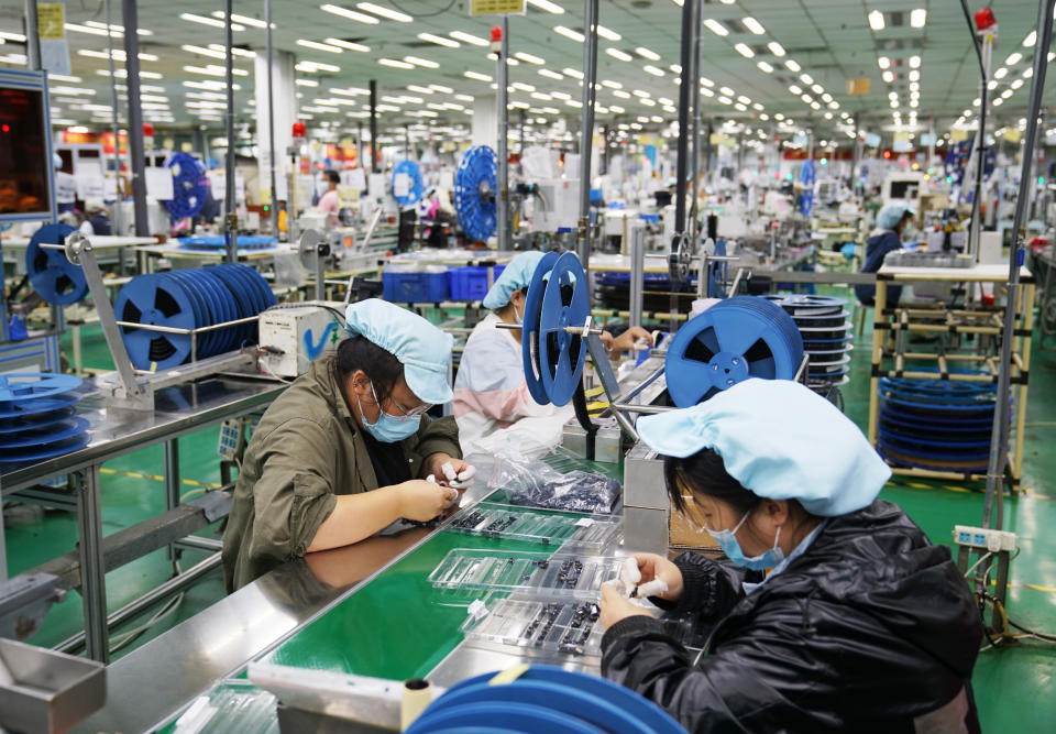 ZHONGMU, CHINA - SEPTEMBER 04: Employee work at a Foxconn factory on September 4, 2021 in Zhongmu County, Zhengzhou City, Henan Province of China. (Photo by VCG/VCG via Getty Images)