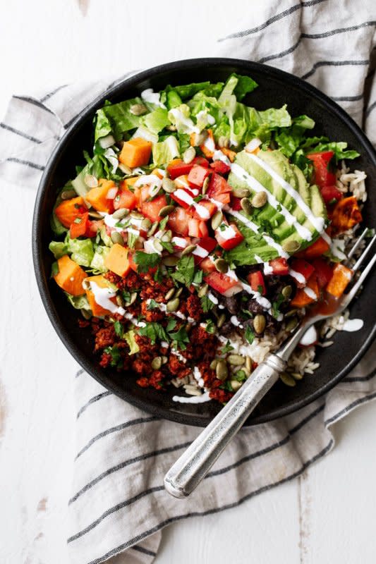 <p>Cooking with Cocktail Rings</p><p>You'll love this protein-packed bowl filled with chorizo made from soy, brown rice, black beans, sweet potatoes, lettuce, guacamole and sour cream.</p><p><strong>Get the recipe: <a href="https://cookingwithcocktailrings.com/2016-brown-rice-black-bean-sweet-potato-bowl/" rel="nofollow noopener" target="_blank" data-ylk="slk:Brown Rice Black Bean and Sweet Potato Bowl;elm:context_link;itc:0;sec:content-canvas" class="link ">Brown Rice Black Bean and Sweet Potato Bowl</a></strong></p>