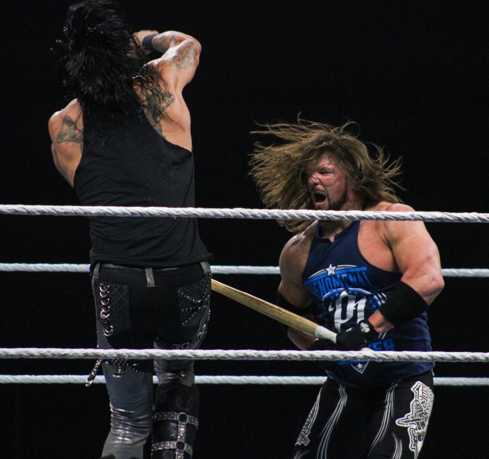 AJ Styles hits Damian Priest with a kendo stick in an Amarillo Street Fight match during the WWE Saturday Night's Main Event house show in the Amarillo Civic Center on Saturday, June 25, 2022.