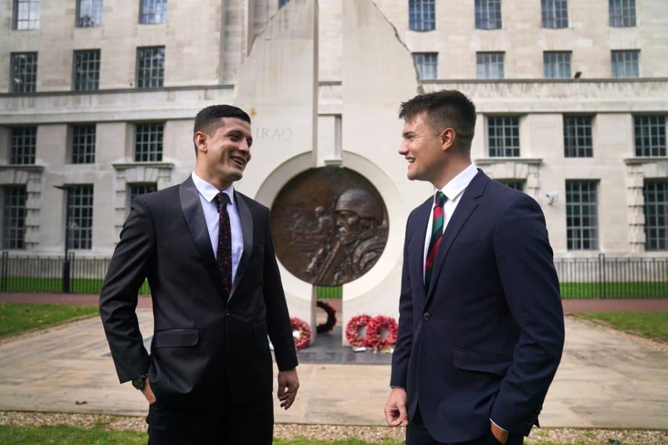 First Lieutenant Mohammad Jawad Akbari and Captain Dave Kellett talk to each other by the Iraq Afghanistan Memorial at the Ministry of Defence building in Westminster (Victoria Jones/PA) (PA Wire)