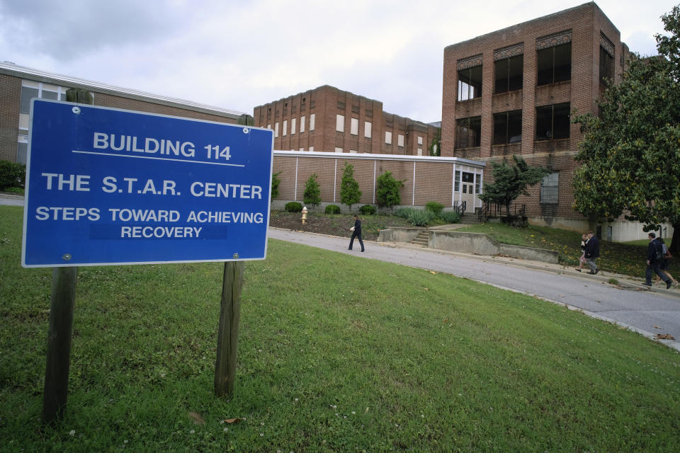Visitors walk toward Building 114, the S.T.A.R. Center, at Central State Hospital in Dinwiddie County, Va., on May 17, 2018. Seven Virginia sheriff's office employees have been charged with second-degree murder in connection with the death of a 28-year-old man at Central State Hospital last week, a local prosecutor said Tuesday, March 14, 2023. (Bob Brown/Richmond Times-Dispatch via AP)