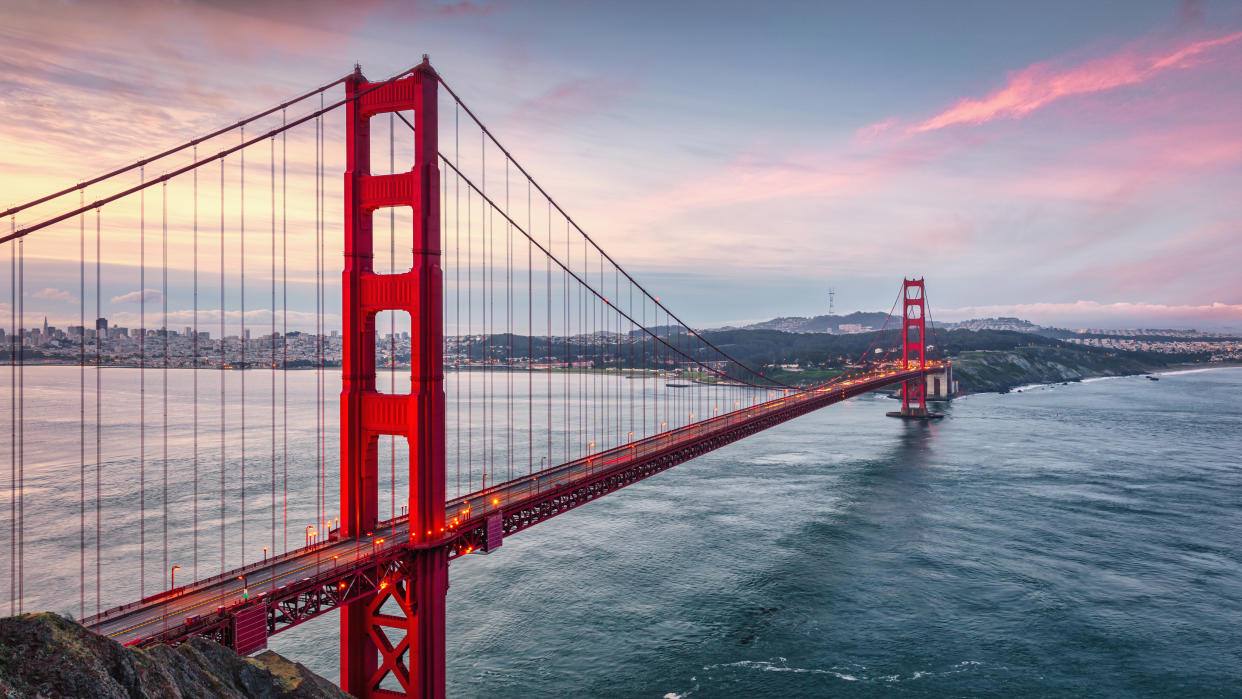 Golden Gate Bridge Sunrise Panorama. Beautiful iconic Golden Gate Bridge at early morning sunrise twilight. Long Time Exposure, Panorama Shot. Golden Gate Bridge, San Francisco, California, USA, North America.