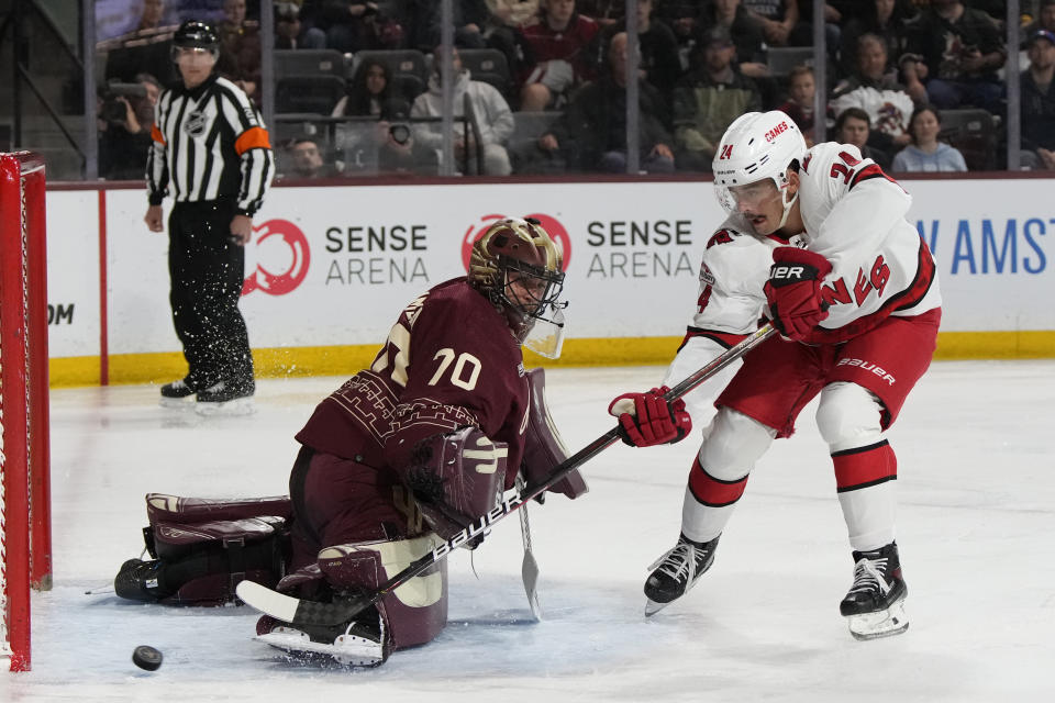 Arizona Coyotes goaltender Karel Vejmelka (70) makes a save against Carolina Hurricanes center Seth Jarvis in the second period during an NHL hockey game, Friday, March 3, 2023, in Tempe, Ariz. (AP Photo/Rick Scuteri)