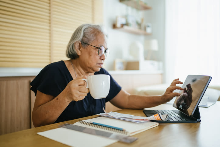 An elderly woman is reviewing her retirement savings.