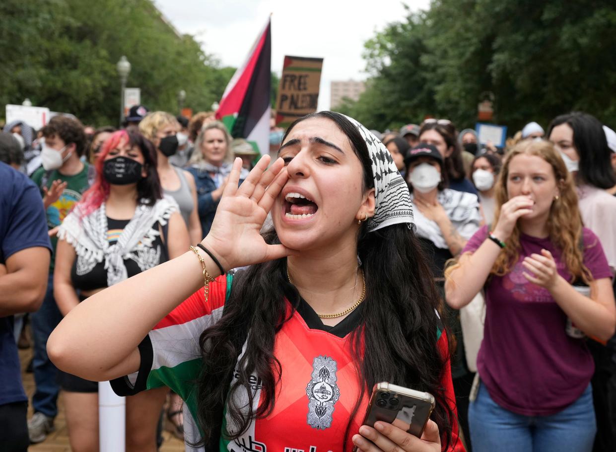 A pro-Palestinian protester, who did not want to give her name, leads chants at the University of Texas Wednesday April 24, 2024.