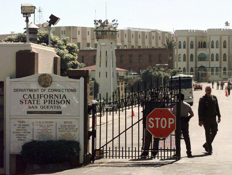 FILE - Guards mobilize near the front gate of San Quentin Prison in preparation for the scheduled execution of Thomas Thompson, July 13, 1998, in San Quentin, Calif. The infamous state prison on San Francisco Bay that has been home to the largest death row population in the United States will be transformed into a lockup where less-dangerous prisoners will receive education, training and rehabilitation under a new plan from California Gov. Gavin Newsom. (AP Photo/Ben Margot, File)