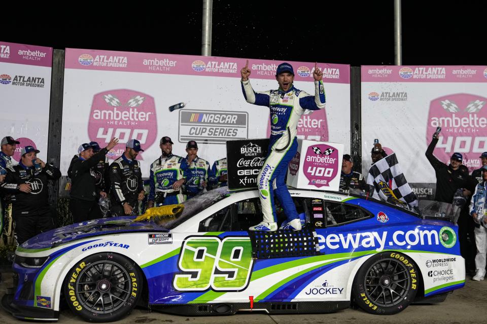 Daniel Suarez (99) celebrates in victory lane after winning the Ambetter Health 400, Sunday at Atlanta Motor Speedway.