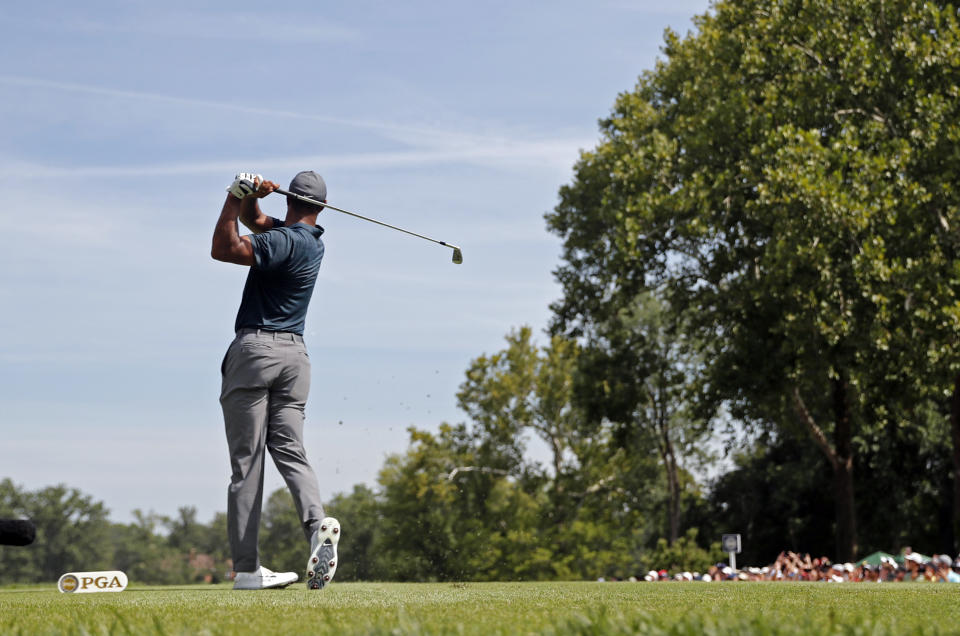 Tiger Woods watches his tee shot on the second hole during the first round of the PGA Championship golf tournament at Bellerive Country Club, Thursday, Aug. 9, 2018, in St. Louis. (AP Photo/Jeff Roberson)