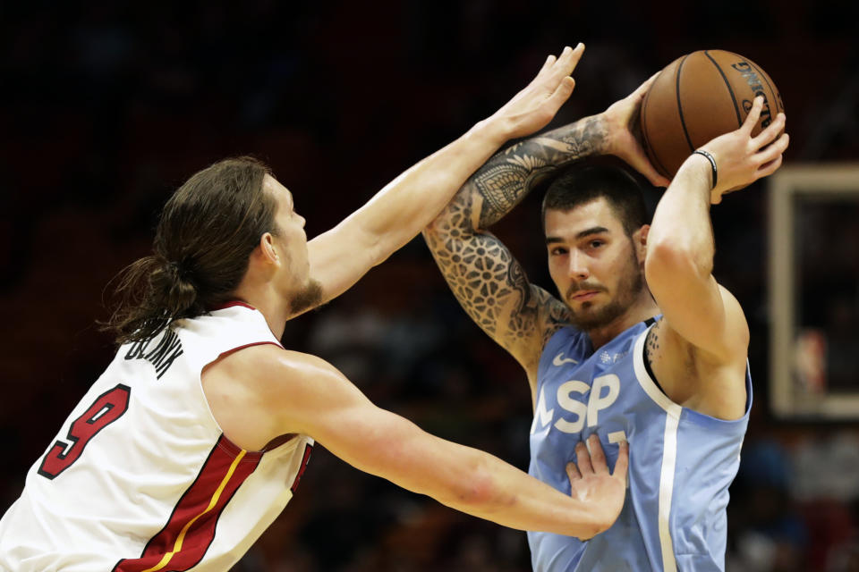 Minnesota Timberwolves forward Juancho Hernangomez, right, looks for an opening past Miami Heat forward Kelly Olynyk (9) during the first half of an NBA basketball game, Wednesday, Feb. 26, 2020, in Miami. (AP Photo/Wilfredo Lee)