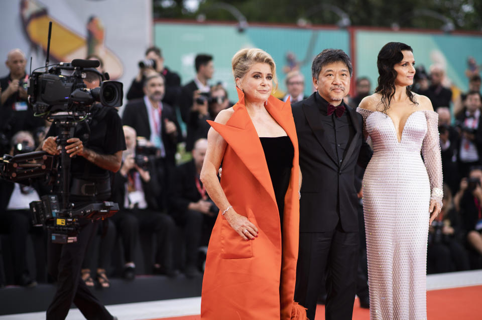 Actress Juliette Binoche, from right, director Kore-eda Hirokazu, and actress Catherine Deneuve pose for photographers upon arrival at the premiere of the film 'The Truth' and the opening gala at the 76th edition of the Venice Film Festival, Venice, Italy, Wednesday, Aug. 28, 2019. (Photo by Arthur Mola/Invision/AP)