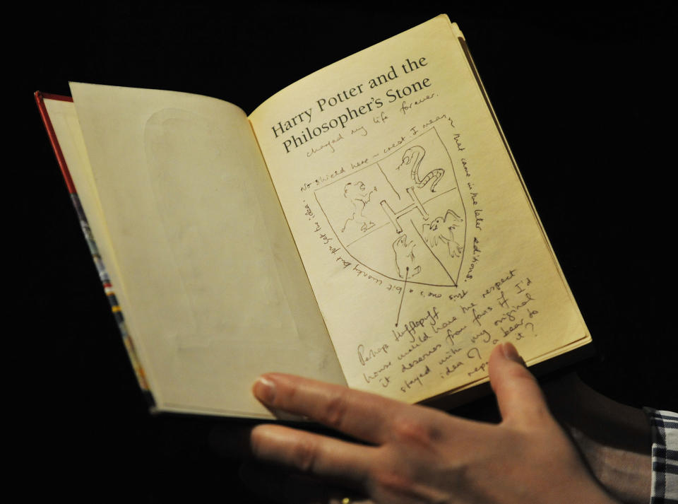 Dr Philip Errington, director of printed books and manuscripts at Sotheby's in London holds a first editor Harry Potter book annotated by author JK Rowling. (Nick Ansell/PA Wire)