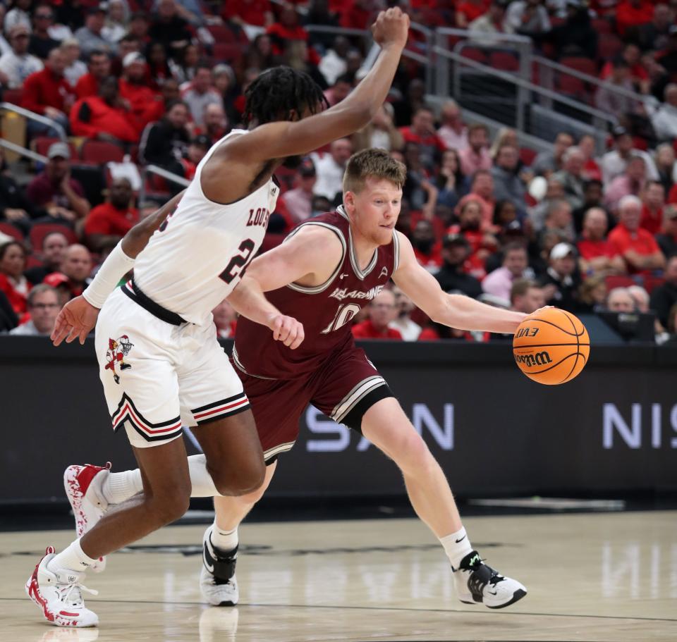 Bellarmine’s Garrett Tipton drive the ball up the court against Louisville’s Jae’Lyn Withers.   Nov. 9, 2022