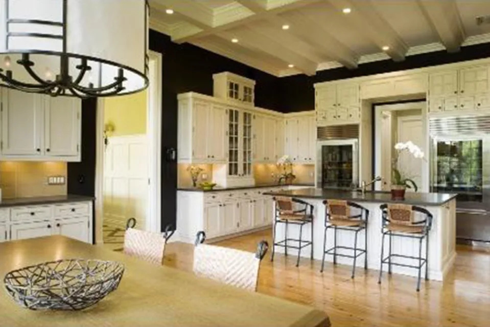 The open floor plan features a sleek kitchen and a dining room area. The Corcoran Group