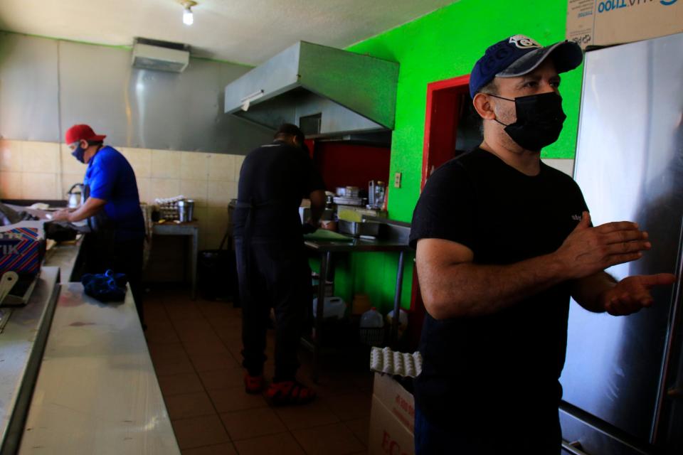 Juan Alberto Huerta sells burritos at his Los Metiches restaurant Wednesday in  Juárez.