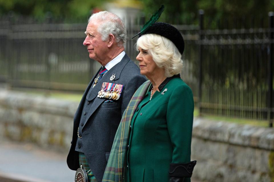 In this picture released by Clarence House, Prince Charles, Prince of Wales and Camilla, Duchess of Cornwall (known as the Duke and Duchess of Rothesay when in Scotland) take part in a two minute silence to mark the 75th anniversary of VE Day at the Balmoral War Memorial on May 8, 2020 near Crathie, United Kingdom. During the event the Prince of Wales laid a wreath and the Duchess of Cornwall placed flowers at the memorial