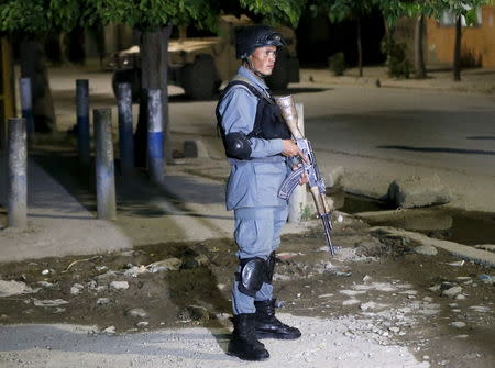 An Afghan policeman keeps watch at the site of an attack in Kabul May 13, 2015. REUTERS/Omar Sobhani