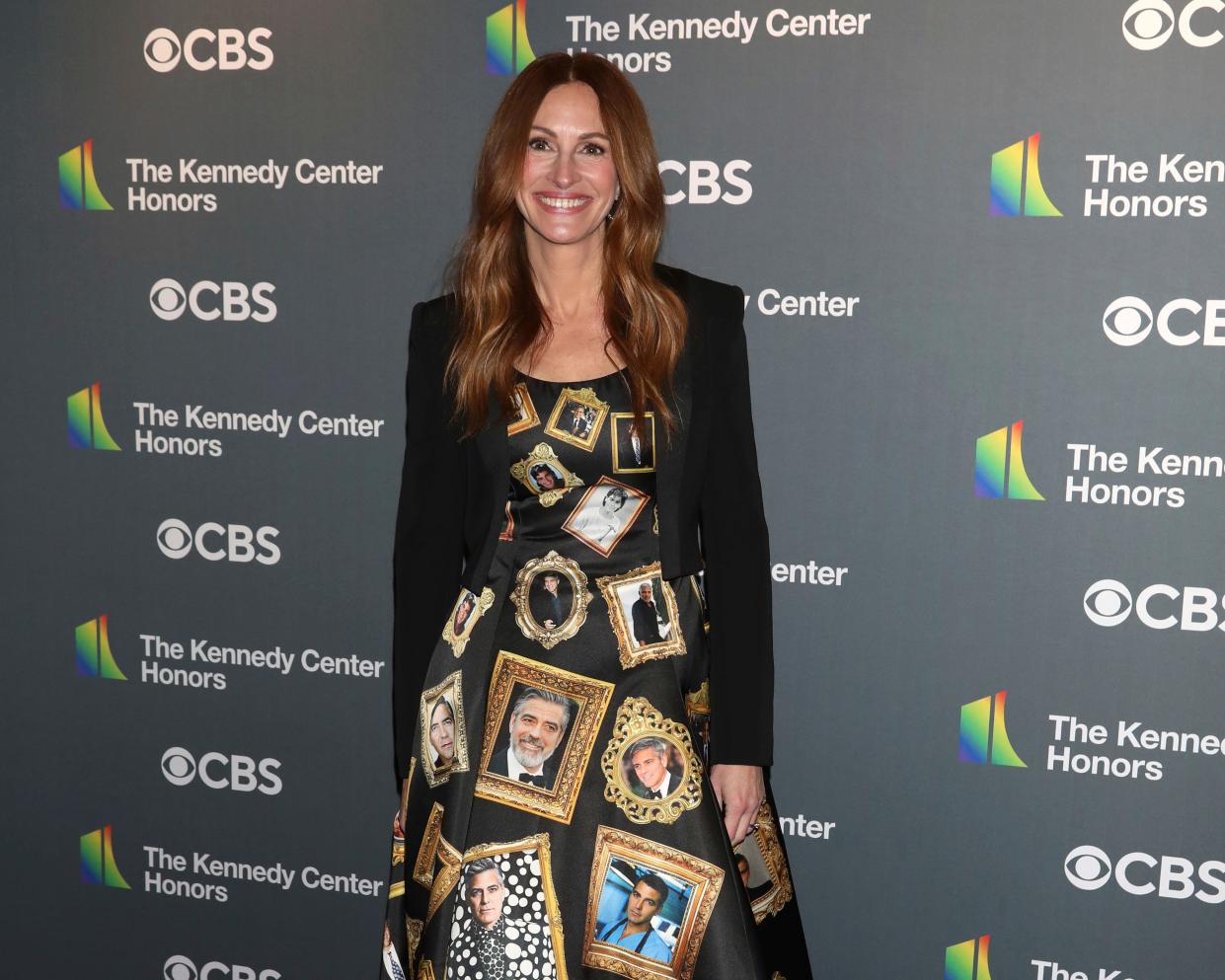 Julia Roberts arrives at the Kennedy Center Honors in a black Moschino gown covered in pictures of actor George Clooney.