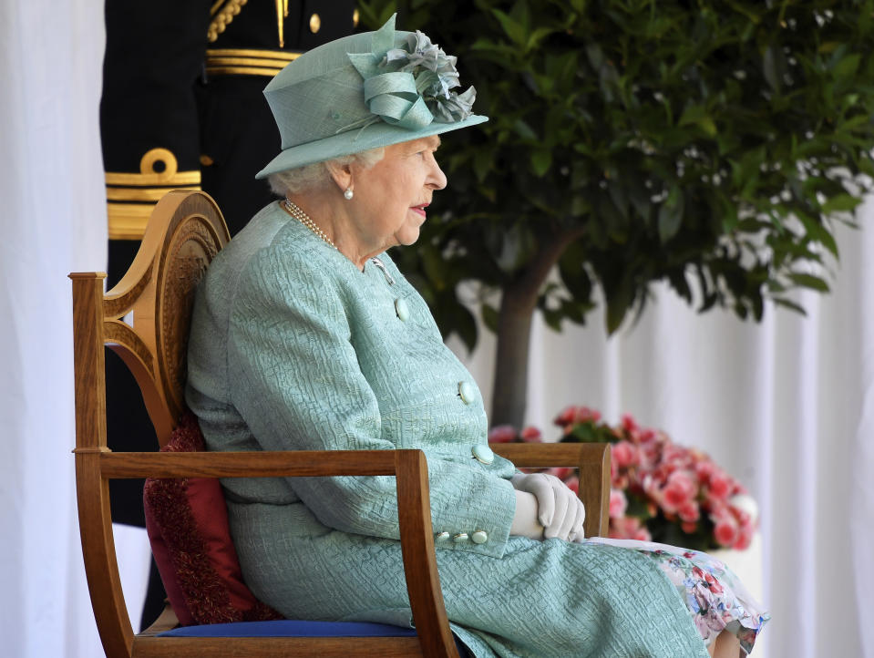 Britain's Queen Elizabeth II attends a ceremony to mark her official birthday at Windsor Castle in Windsor, England, Saturday June 13, 2020. Queen Elizabeth II’s birthday is being marked with a smaller ceremony than usual this year, as the annual Trooping the Color parade is canceled amid the coronavirus pandemic. The Queen celebrates her 94th birthday this year. (Toby Melville/Pool via AP)