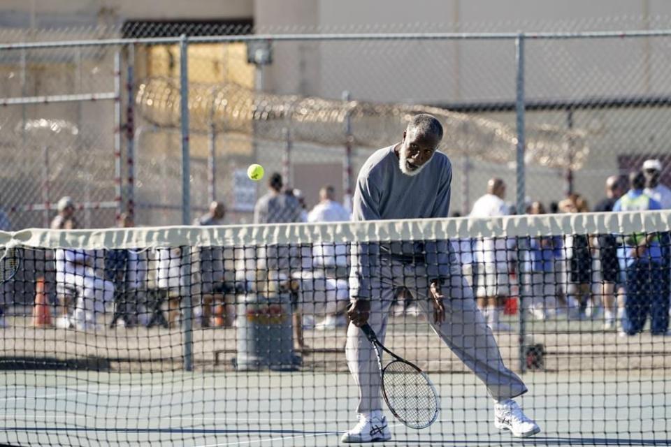 Earl Wilson, an inmate at San Quentin State Prison, hits a return during a tennis match against visiting players in San Quentin, Calif., Saturday, Aug. 13, 2022. (AP Photo/Godofredo A. Vásquez)