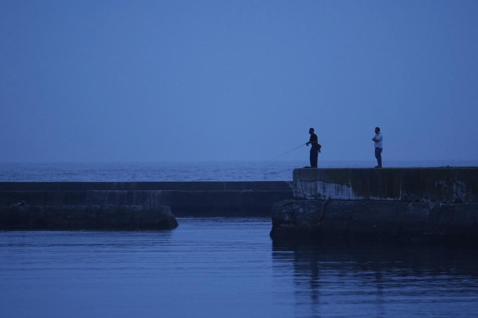 People try to catch fish at the Numanouchi fishery port in Iwaki, northeastern Japan, Saturday, July 15, 2023. (AP Photo/Hiro Komae)