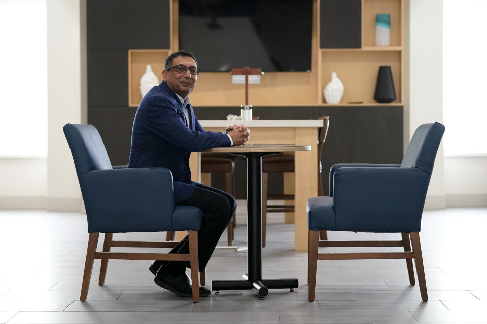 Vimal Patel president of Q Hotels, poses for a photograph at his Holiday Inn Express Hotel in LaPlace, La., Wednesday, June 23, 2021. (AP Photo/Gerald Herbert)