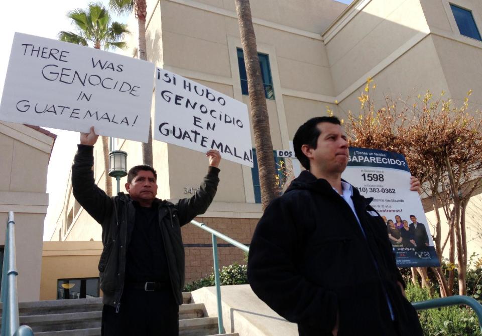 Demonstrators stand outside the federal courthouse in Riverside, Calif. on Monday, Feb. 10, 2014, after the sentencing of Jorge Sosa, a former second lieutenant of the Guatemalan army, who was convicted to ten years in prison for making false statements on his U.S. citizenship application. Sosa was a member of a special force suspected of killing at least 160 people in a remote village more than three decades ago in a massacre that still haunts its few survivors. Oscar Ramirez front right, spoke during Sosa's sentencing about how his mother and seven siblings were killed in the civil war massacre. (AP Photo/Amy Taxin)