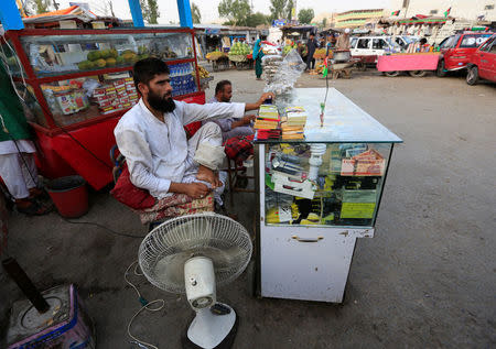 Mehrullah Safi 28, disable Afghan National Army (ANA) soldier, sells mobile phone cards in Jalalabad province, Afghanistan. August 9, 2017. REUTERS/Parwiz