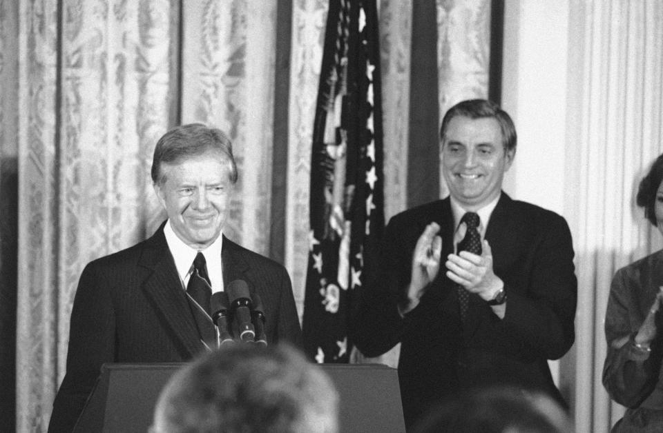 FILE - Vice President Walter Mondale applauds as President Jimmy Carter finishes his announcement that he will seek re-election, in the East Room of the White House in Washington on Dec. 4, 1979. His reelection bid was defeated by Ronald Reagan, a Republican. (AP Photo, File)