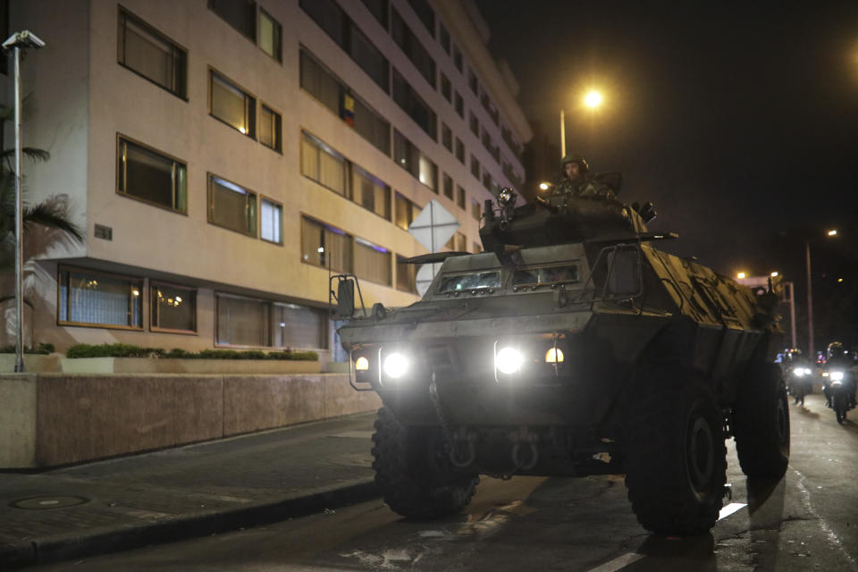 A military vehicle patrols the streets in Bogota, Colombia, Saturday, Nov. 23, 2019. Authorities in Colombia are maintaining a heightened police and military presence in the nation's capital following two days of unrest. (AP Photo/Ivan Valencia)