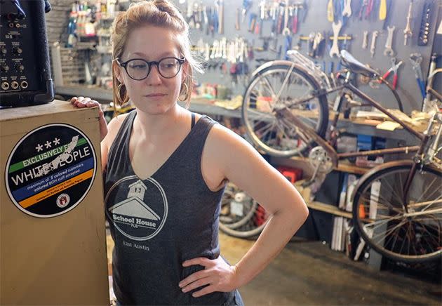 Sarah Goeth, co-owner of Windmill Bicycles, stands next to a sticker that was placed on her Manor Road business on Wednesday. Photo: American-Statesman/Rodolfo Gonzalez/Statesman.com