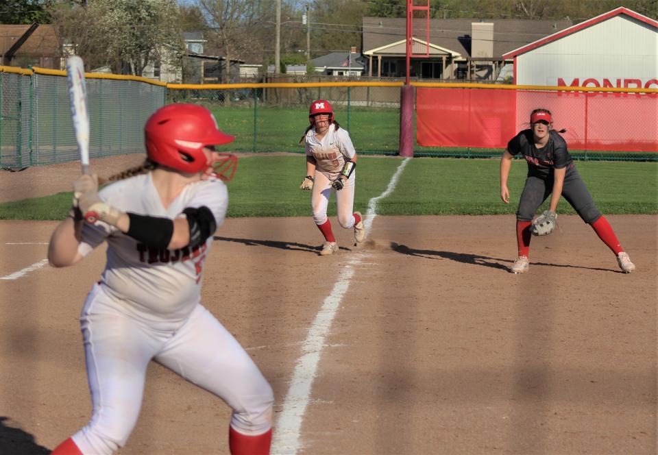 Monroe's Avery Collette prepares to run home from third as teammate Alana Aulph bats against Bedford on Monday, May 9, 2022. At third base for Bedford is Nyah Mullins.