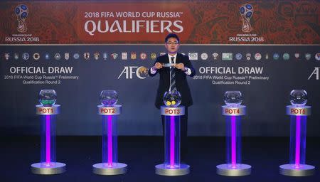 Asian Football Confederation's Shin Man Gil draws Afghanistan for Group E in the 2018 FIFA World Cup Asian qualifiers during the preliminary joint qualification round 2 draw in Kuala Lumpur, April 14, 2015. REUTERS/Olivia Harris