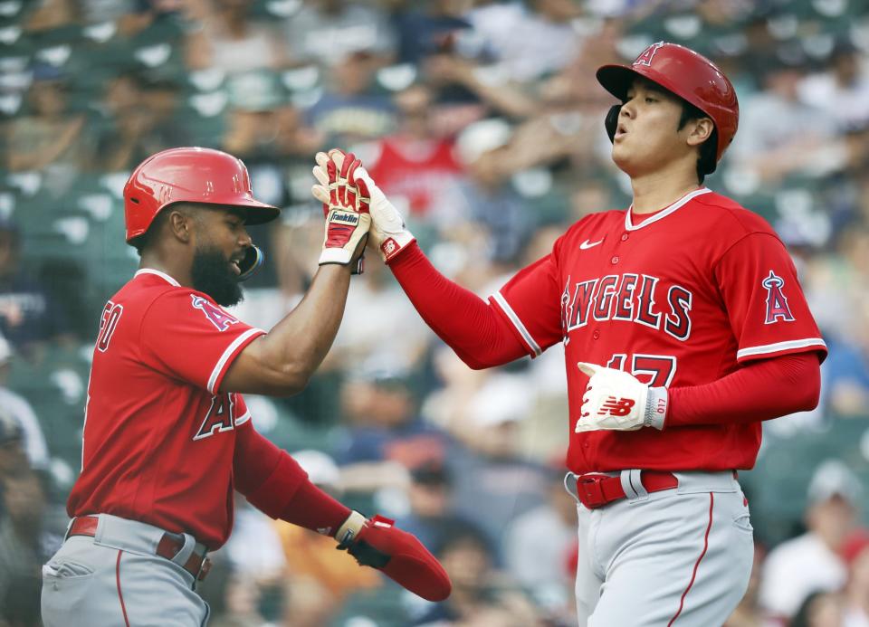 Angels second basaeman Luis Rengifo celebrates with designated hitter Shohei Ohtani after they scored against the Tigers on a double by third baseman Mike Moustakas during the first inning on Tuesday, July 25, 2023, at Comerica Park.