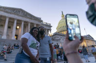 Rep. Cori Bush, D-Mo., take a picture with a supporter as she camps outside the U.S. Capitol, in Washington, Monday, Aug. 2, 2021, as anger and frustration has mounted in Congress after a nationwide eviction moratorium expired at midnight Saturday. (AP Photo/Jose Luis Magana)