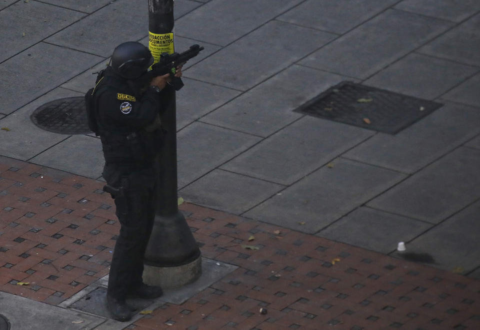 <p>A security forces member aims his weapon after clashes broke out with opposition supporters while the Constituent Assembly election was being carried out in Caracas, Venezuela, July 30, 2017. (Carlos Garcia Rawlins/Reuters) </p>