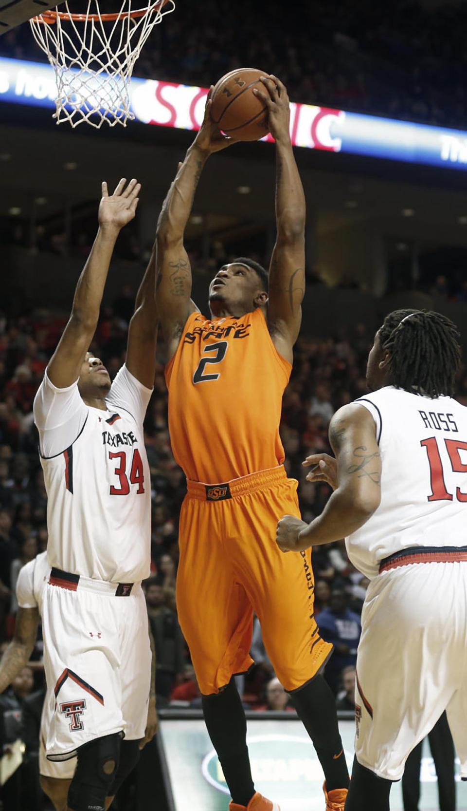 Oklahoma State's Le'Bryan Nash (2) looks to score over Texas Tech's Alex Foster (34) and Aaron Ross (15) during their NCAA college basketball game in Lubbock, Texas, Saturday, Feb, 8, 2014. (AP Photo/Lubbock Avalanche-Journal, Tori Eichberger) ALL LOCAL TV OUT