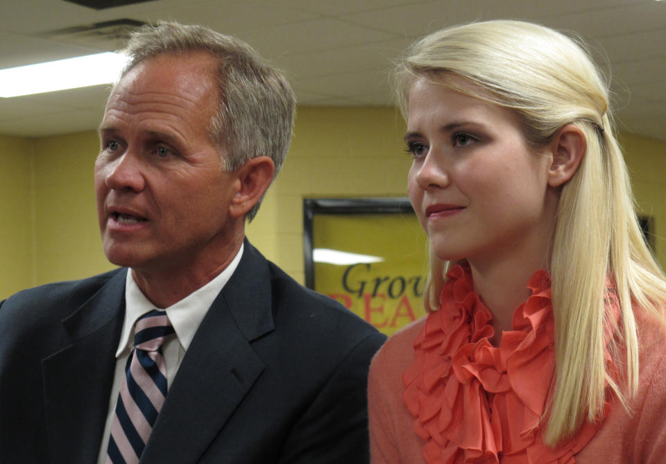 FILE - In this Aug. 27, 2012 file photo, Ed Smart, left, and daughter Elizabeth Smart talk to reporters before her speech at Scotts Hill High School, where missing Tennessee woman Holly Bobo graduated from, in Scotts Hill, Tenn. The father of Utah kidnapping survivor Elizabeth Smart has come out as gay, saying his decision brings challenges but also “huge relief.” Ed Smart said in a letter shared Friday, Aug. 16, 2019, with NBC's "Today" show that he no longer feels comfortable being a member of The Church of Jesus Christ of Latter-day Saints, which opposes same-sex relationships. (AP Photo/Adrian Sainz, File)