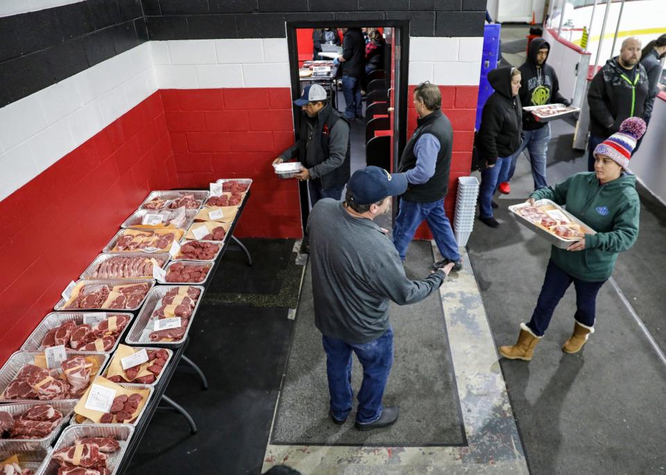 Trays of cut meat are transported to the locker room to be judged during the first round of the Texas Roadhouse Qualifier meat cutting challenge at Big Boy Arena in Fraser, Mich. on Tuesday, Sept. 19, 2023.