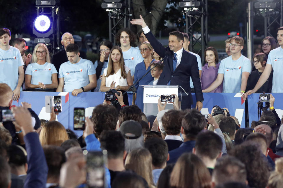 Presidential candidate Rafal Trzaskowski gestures while addressing supporters at the end of the election day in Warsaw, Poland, Sunday, July 12, 2020. Voting ended in Poland's razor-blade-close presidential election runoff between the conservative incumbent Andrzej Duda and liberal, pro-European Union Warsaw Mayor Rafal Trzaskowski with exit polls showing the election is too close to call. (AP Photo/Petr David Josek)