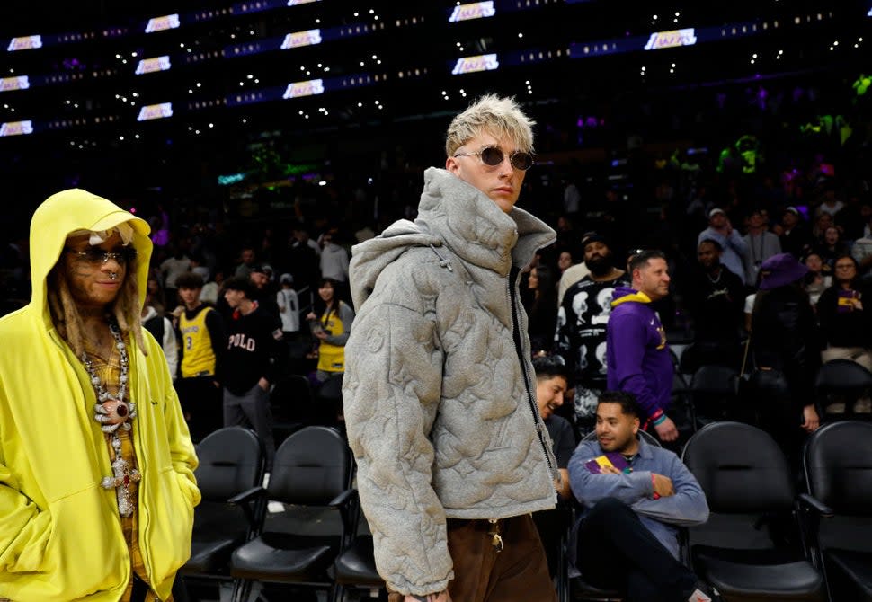 Machine Gun Kelly (R) and Trippie Redd attend the game between Los Angeles Lakers and Milwaukee Bucks at Crypto.com Arena on March 8, 2024 in Los Angeles, California. NOTE TO USER: User expressly acknowledges and agrees that, by downloading and or using this photograph, User is consenting to the terms and conditions of the Getty Images License Agreement.