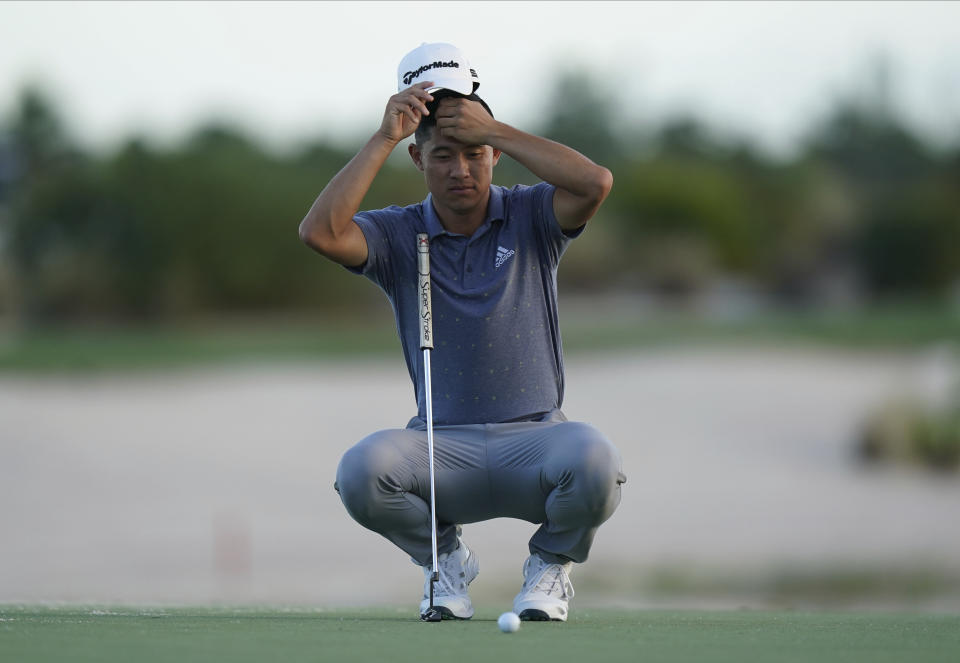 Collin Morikawa of the United States, adjusts his cap as he prepares a putter shot on the 17th green on day three of the Hero World Challenge PGA Tour at the Albany Golf Club, in New Providence, Bahamas, Saturday, Dec. 4, 2021.(AP Photo/Fernando Llano)