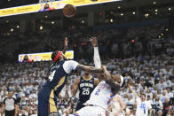 New Orleans Pelicans forward Brandon Ingram (14) tries to block a shot by Oklahoma City Thunder guard Shai Gilgeous-Alexander (2) in the first half of Game 1 of an NBA basketball first-round playoff series, Sunday, April 21, 2024, in Oklahoma City. (AP Photo/Kyle Phillips)